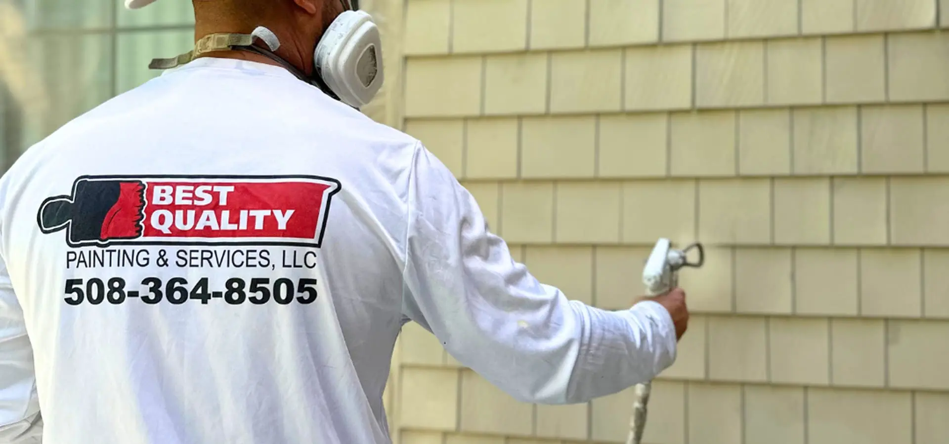 Professional painter applying fresh paint to an interior wall