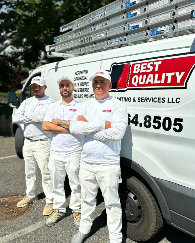 Best Quality Painting crew standing together at a completed job site