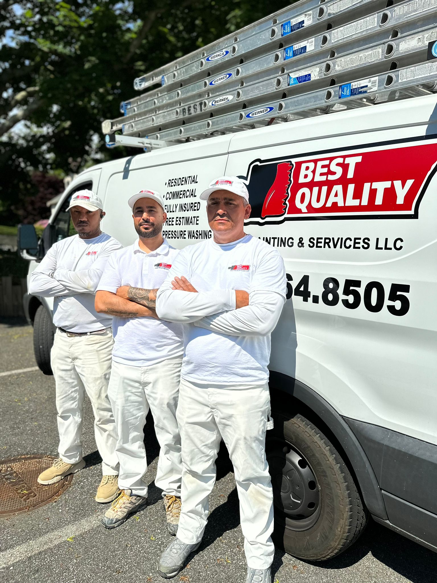 Best Quality Painting crew standing together at a completed job site